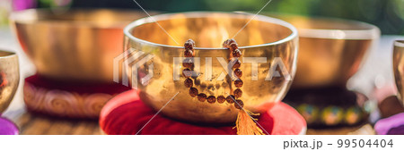 Tibetan singing bowls on a straw mat BANNER, LONG FORMAT 99504404