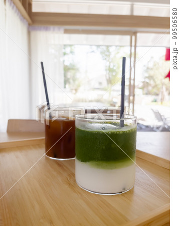 Iced americano with orange and iced matcha green tea in coffee shop 99506580