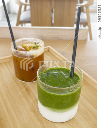 Iced americano with orange and iced matcha green tea in coffee shop Iced americano with orange and iced matcha green tea in coffee shop 99506581
