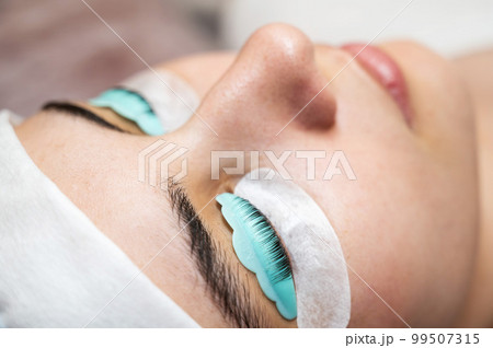 Portrait of a woman in a beauty salon on the procedure of eyelash lamination. Portrait of a woman in a beauty salon on the procedure of eyelash lamination. 99507315