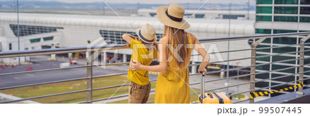 BANNER, LONG FORMAT Family at airport before flight. Mother and son waiting to board at departure gate of modern international terminal. Traveling and flying with children. Mom with kid boarding BANNER, LONG FORMAT Family at airport before flight. Mother and son waiting to board at departure gate of modern international terminal. Traveling and flying with children. Mom with kid boarding 99507445