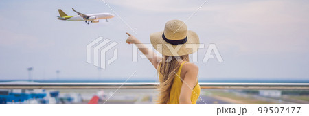 Start of her journey. Beautiful young woman ltraveler in a yellow dress and a yellow suitcase is waiting for her flight BANNER, LONG FORMAT 99507477