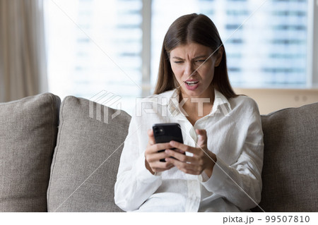 Annoyed shocked upset millennial girl facing problems with online application 99507810
