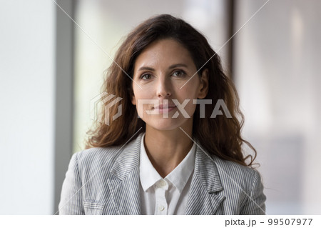 Positive beautiful millennial young businesswoman head shot face portrait 99507977
