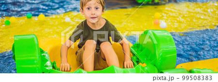 Happy young boy on the boat enjoying playing on amusement park BANNER, LONG FORMAT Happy young boy on the boat enjoying playing on amusement park BANNER, LONG FORMAT 99508383