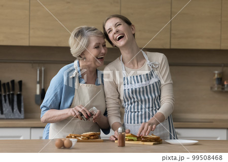 Happy excited elder mother and adult daughter woman 99508468