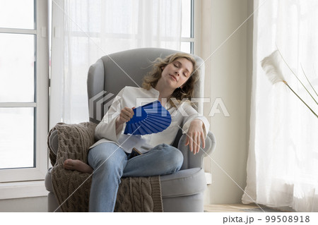 Tired relaxed beautiful young woman suffering from heat 99508918