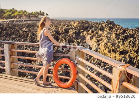 Young woman on the rocks in Bali, Nusadua, Waterbloom Fountain Young woman on the rocks in Bali, Nusadua, Waterbloom Fountain 99513620