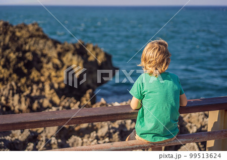 Boy traveler on amazing Nusadua, Waterbloom Fountain, Bali Island Indonesia. Traveling with kids concept Boy traveler on amazing Nusadua, Waterbloom Fountain, Bali Island Indonesia. Traveling with kids concept 99513624