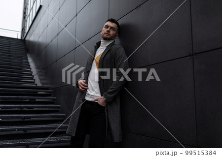 adult caucasian men on the background of the gray wall of the building 99515384