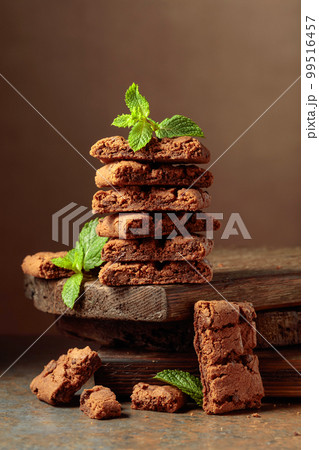 Pieces of fresh brownie with mint. 99516457