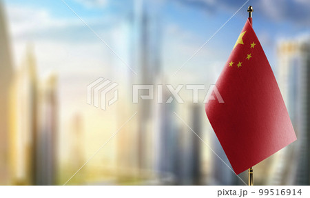 Small flags of the China on an abstract blurry background 99516914