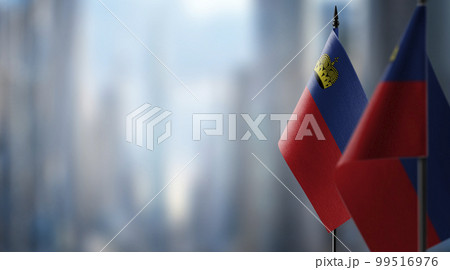 Small flags of the Liechtenstein on an abstract blurry background 99516976