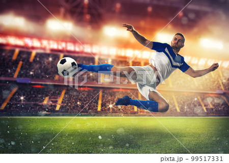 Soccer striker hits the ball with an acrobatic kick 99517331