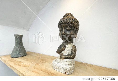 Small statue decorations for table and interior, little buddha statue modern simplistic house environment with several pottery and wooden table Small statue decorations for table and interior, little buddha statue modern simplistic house environment with several pottery and wooden table 99517360