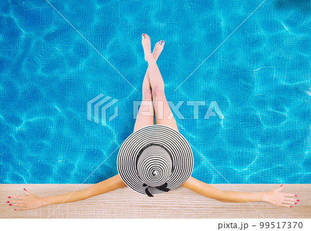 Girl with hat at the swimming pool. Concept of summer relax Girl with hat at the swimming pool. Concept of summer relax 99517370