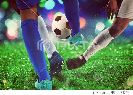 Football scene with competing soccer players at the stadium 99517876