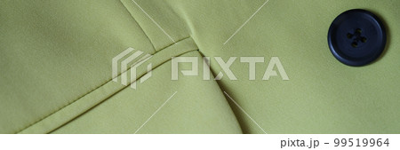 Closeup of green jacket with black button and pocket Closeup of green jacket with black button and pocket 99519964