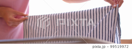 Clothes dryer with towels and linens on balcony in sunlight Clothes dryer with towels and linens on balcony in sunlight 99519972