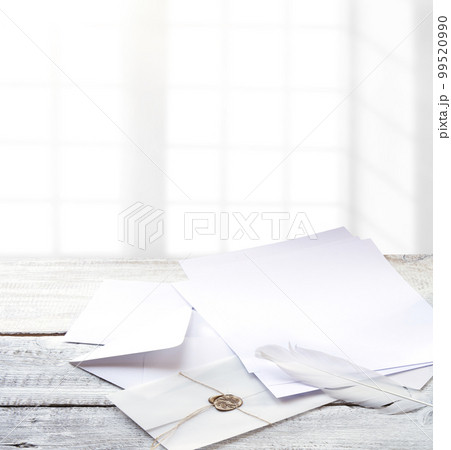 Envelope and paper on white wooden table 99520990