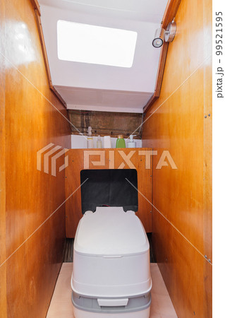 Cozy bathroom in small yacht with wooden walls. Compact stylish modern thoughtful yacht. Concept of comfortable conditions while traveling. 99521595