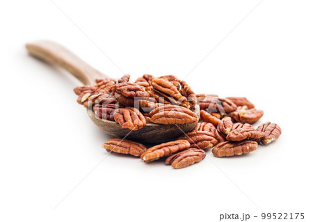 Peeled pecan nuts in wooden spoon isolated on white background. 99522175