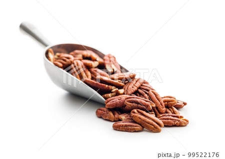 Peeled pecan nuts in scoop isolated on white background. Peeled pecan nuts in scoop isolated on white background. 99522176