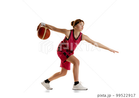 Teen girl, professional basketball player in motion, training isolated over white studio background. Concept of professional sport and hobby Teen girl, professional basketball player in motion, training isolated over white studio background. Concept of professional sport and hobby 99522917