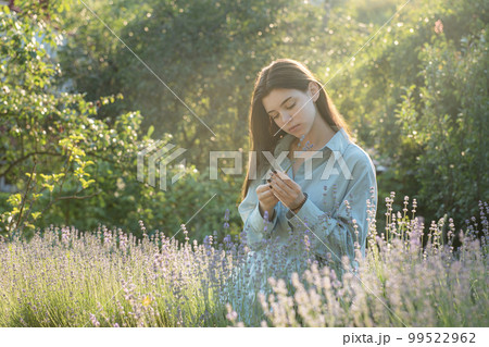 Beautiful young girl on lavender field. 99522962