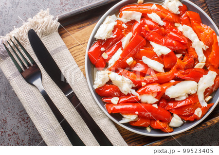 Esgarraet Red pepper and cod salad is a typical Valencian dish closeup on the plate. Horizontal top view Esgarraet Red pepper and cod salad is a typical Valencian dish closeup on the plate. Horizontal top view 99523405