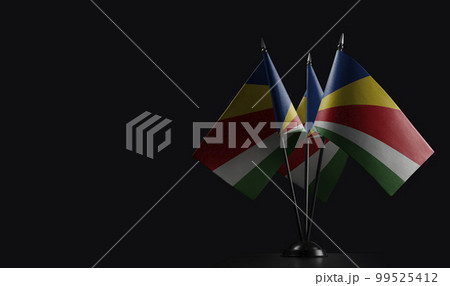 Small national flags of the Seychelles on a black background 99525412