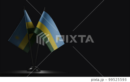 Small national flags of the Rwanda on a black background 99525593