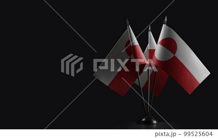 Small national flags of the Greenland on a black background 99525604