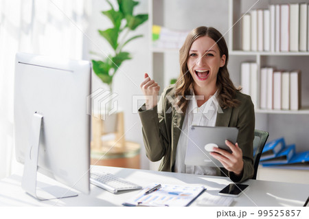 Concept of business investment or working woman, Businesswoman wearing a suit sitting and smiling while working on analysis of business investment documents and using tablet to analytic business data Concept of business investment or working woman, Businesswoman wearing a suit sitting and smiling while working on analysis of business investment documents and using tablet to analytic business data 99525857