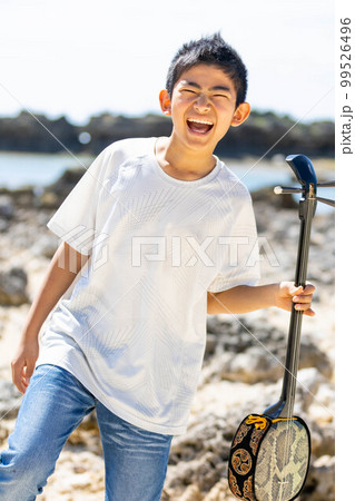 沖縄三線と笑顔の少年 99526496