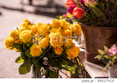 Different flowers and seedlings near the florist flower shop entrance, spring time, easter concept Different flowers and seedlings near the florist flower shop entrance, spring time, easter concept 99527418