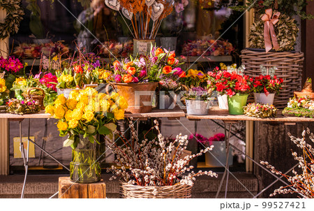 Different flowers and seedlings near the florist flower shop entrance, spring time, easter concept Different flowers and seedlings near the florist flower shop entrance, spring time, easter concept 99527421