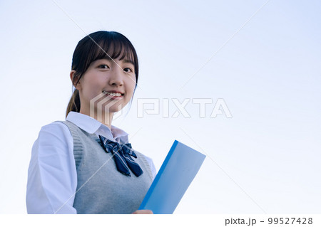 外で遠くを見る制服を着た女子高生 外で遠くを見る制服を着た女子高生 99527428