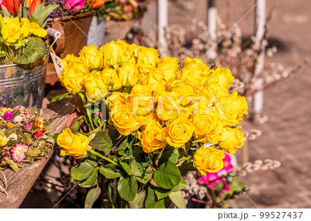 Different flowers and seedlings near the florist flower shop entrance, spring time, easter concept Different flowers and seedlings near the florist flower shop entrance, spring time, easter concept 99527437