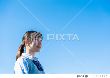 外で遠くを見る制服を着た女子高生 外で遠くを見る制服を着た女子高生 99527457