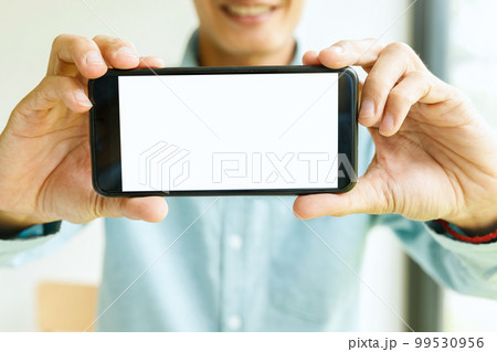Man holding smartphone in hand. Business man showing smartphone. 99530956