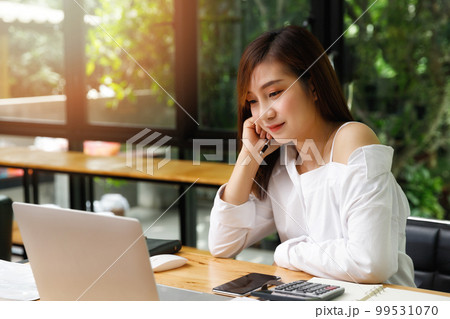 Portrait of a designer holding a pen and smile as she can come up with new ideas. Portrait of a designer holding a pen and smile as she can come up with new ideas. 99531070