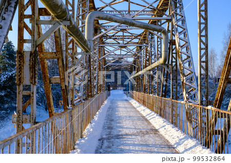 Valmiera bridge in winter. Latvian city bridge. The old railway bridge is no longer in use. Valmiera's famous tourist attraction. 99532864