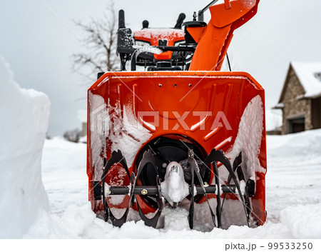 Ground level view looking into the blades of a snow blower  99533250