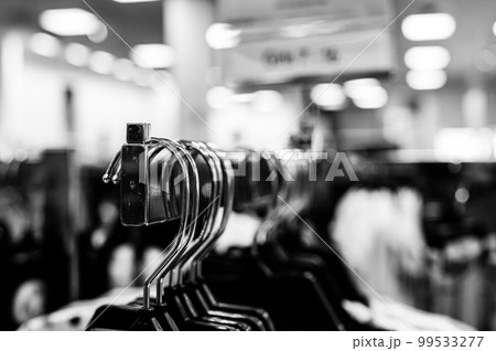 Row of coat hangers on a retail store shelf. Row of coat hangers on a retail store shelf. 99533277