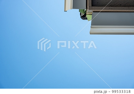 Metal gutters be installed on a residential buildings with two sections coming together for a 90 degree connection.  99533318