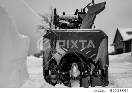 Ground level view looking into the blades of a snow blower  99533342