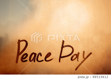 Handwriting message Peace Day on orange sunset window with raindrops 99533612