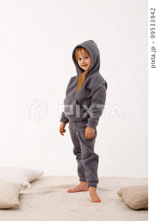 Little girl in thermal clothes, on a white background. 99533942