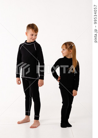 A little girl and her older brother in thermal clothes. A little girl and her older brother in thermal clothes. 99534057